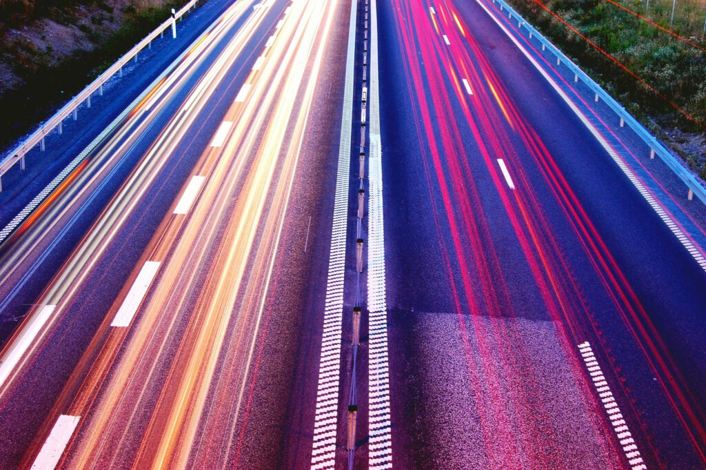 pexels-photo-399636-399636 Long exposure capture of vibrant light trails on a highway at dusk, showcasing motion and speed.